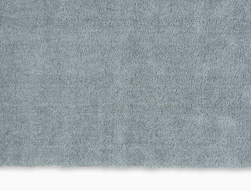 Close-up of the plush texture of the grey Calvin Klein Chicago Shag rug. Soft, handmade polyester shag.
