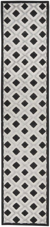 Close-up of Nourison Aloha Black White Modern Area Rug; black diamond pattern on a textured white background.