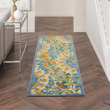 Hallway scene with Nourison Aloha Multicolor rug runner, silver console table, herringbone wood floors.