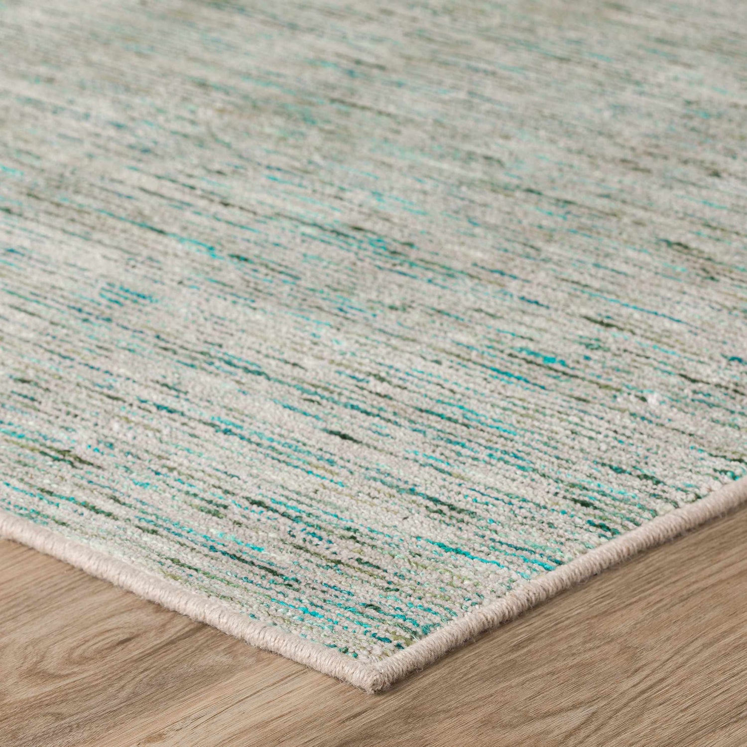 Close-up of Dalyn Arcata AC1 Aruba Area Rug showing aqua, teal, and olive striations on a neutral background.