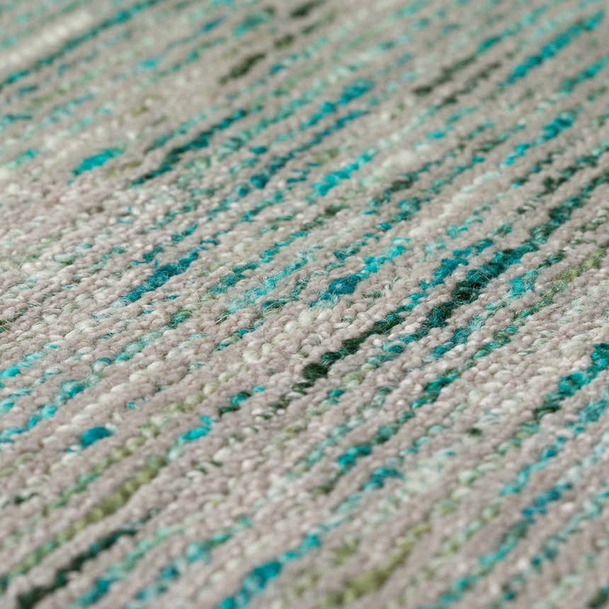 Close-up of the Dalyn Arcata AC1 Aruba Area Rug showing aqua, teal, and olive stripes on a textured, hand-loomed wool blend.