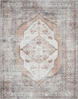 Close-up of Arncliffe Washable Area Rug with a traditional, bohemian pattern in shades of ivory, brown, and orange. Design-Rectangle