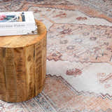 Close up of the Arncliffe Washable Area Rug, a bohemian style rug in peach, tan, and brown, with a traditional oriental pattern. Styleshot