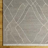 Close-up of the hand-tufted Livabliss Arsenal Surya ARL-2305 area rug. Cream geometric lines on a medium gray wool rug. Swatch