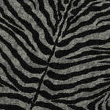 Close-up of Dalyn Akina AK1 Midnight Washable Area Rug with black and taupe zebra stripe pattern.