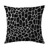 Close-up of Dalyn Machine Akina AK4 Midnight Washable Area Rug; black and white giraffe print pattern.