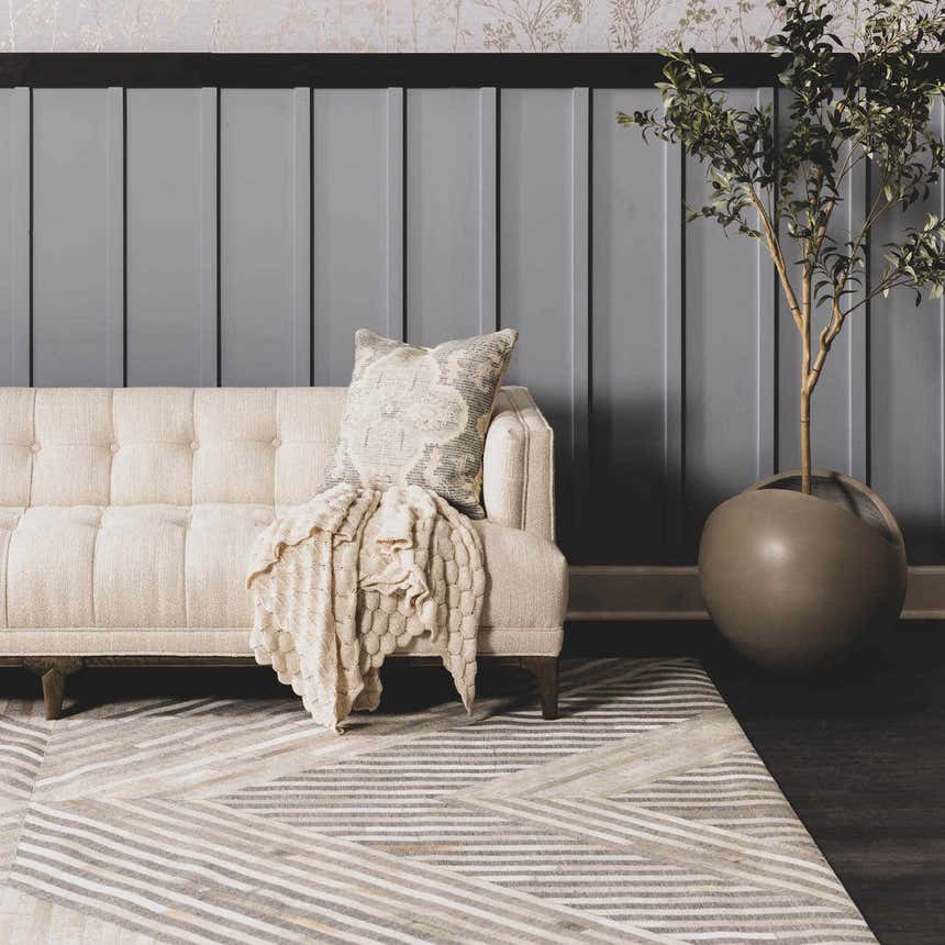 Living room scene with beige sofa on Akiye Area Rug. Geometric pattern in cream, beige, and gray. Modern style. Roomscene-Rectangle