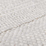 Close-up of the hand woven Alora Area Rug, cream color, wool and viscose blend, showcasing texture. Texture