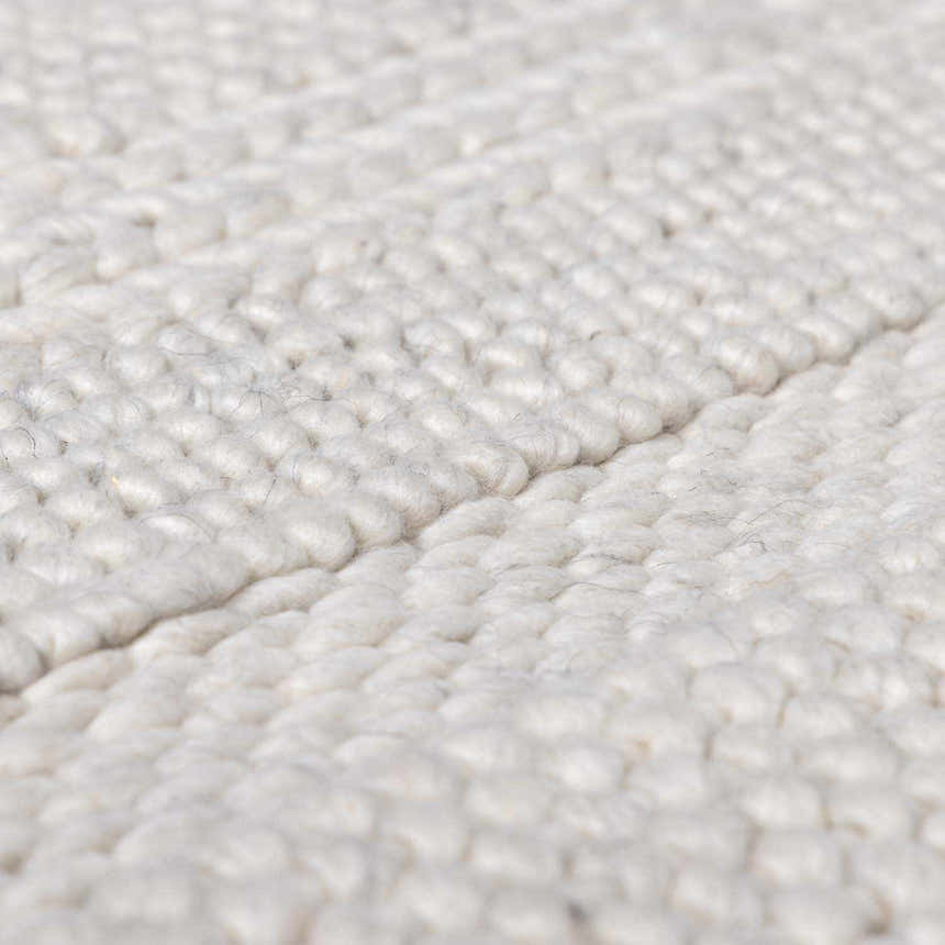 Close-up of the hand woven Alora Area Rug, cream color, wool and viscose blend, showcasing texture. Texture