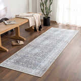 Entryway scene with gray Hedda Boutique Washable Rug, wood bench, cactus, and light neutral decor. Roomscene-Runner