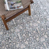 Close-up of the Hedda Boutique Washable Rug. Gray, brown, and nutmeg vintage-style floral pattern. Traditional farmhouse rug. Styleshot