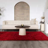 Living room scene with a bright red Sparta area rug, beige sofa, and round coffee table. Roomscene-Rectangle