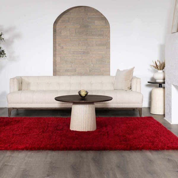 Living room scene with a bright red Sparta area rug, beige sofa, and round coffee table. Roomscene-Rectangle