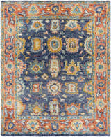 Close-up of the Ankara Premium Wool Area Rug, featuring navy, brick red, and mustard hues in a traditional pattern. Design-Rectangle-810