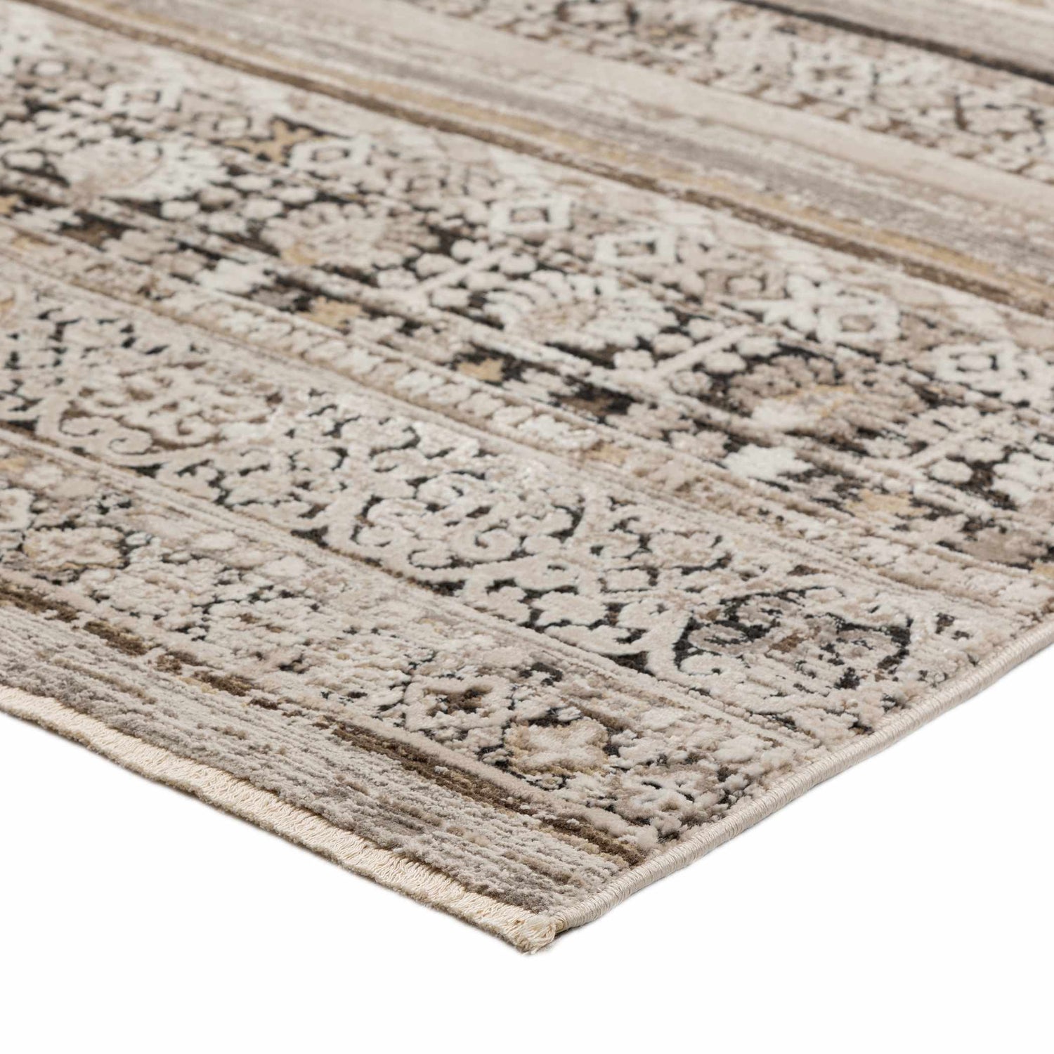 Close-up of the Dalyn Antalya AY1 Taupe Area Rug. Beige, cream, and tan tones with a traditional, distressed pattern.