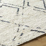 Close-up of the Barlig Beige Trellis Jute Carpet showing the hand-woven texture and black geometric trellis pattern. Texture