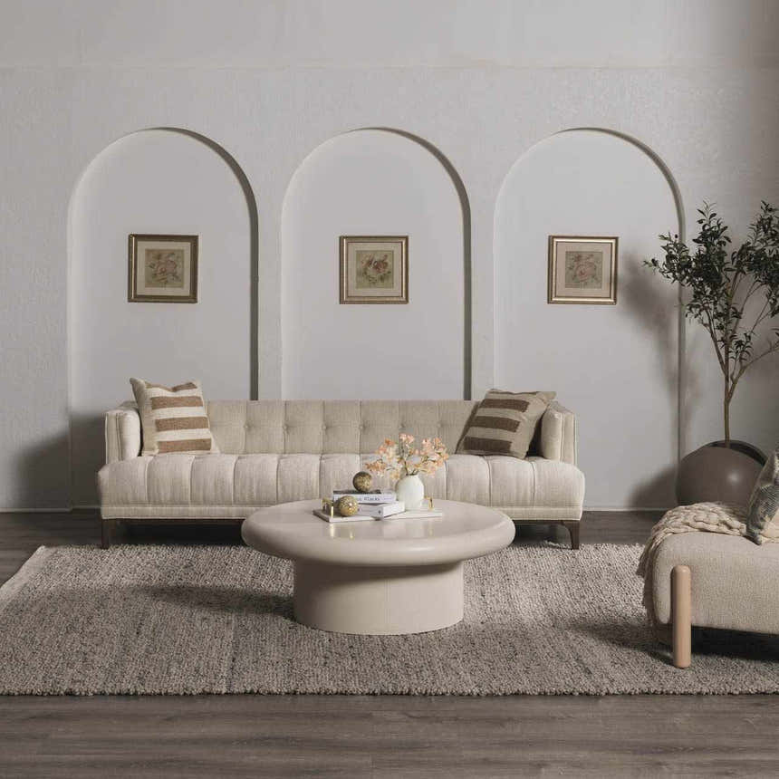 Living room with cream sofa, round coffee table, and charcoal Basiao Area Rug. Contemporary style. Roomscene-Rectangle