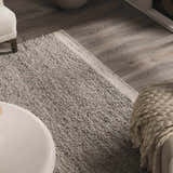 Close-up of the hand woven Basiao Area Rug in charcoal and cream, showcasing its nubby texture and contemporary style. Styleshot