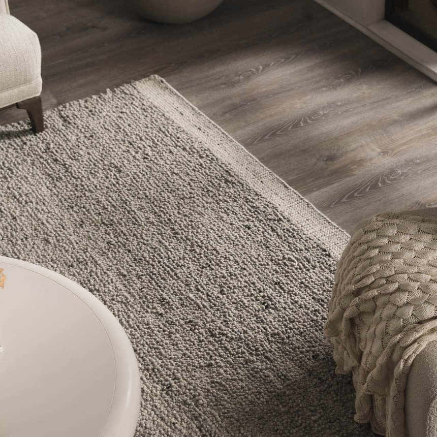 Close-up of the hand woven Basiao Area Rug in charcoal and cream, showcasing its nubby texture and contemporary style. Styleshot