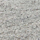 Close-up of the hand-woven Basiao Area Rug, clearance item. Charcoal, cream, and gray wool and cotton texture. Texture