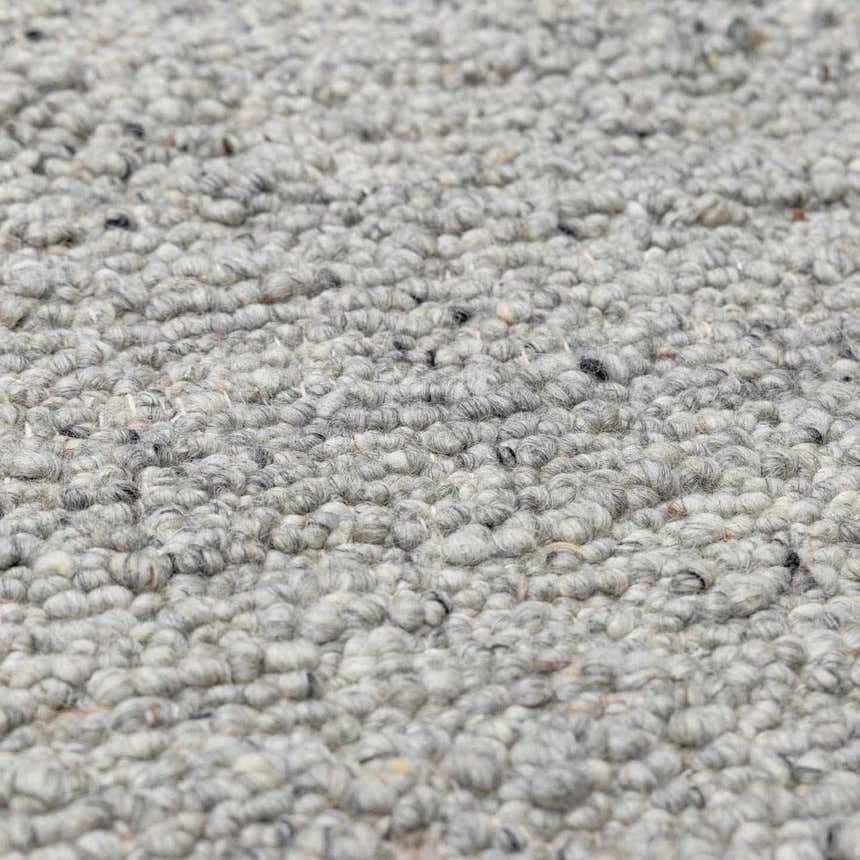 Close-up of the hand-woven Basiao Area Rug, clearance item. Charcoal, cream, and gray wool and cotton texture. Texture