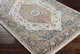 Close-up of a cream, denim, and brown Baychester Area Rug with a traditional oriental pattern on dark wood flooring. Corner