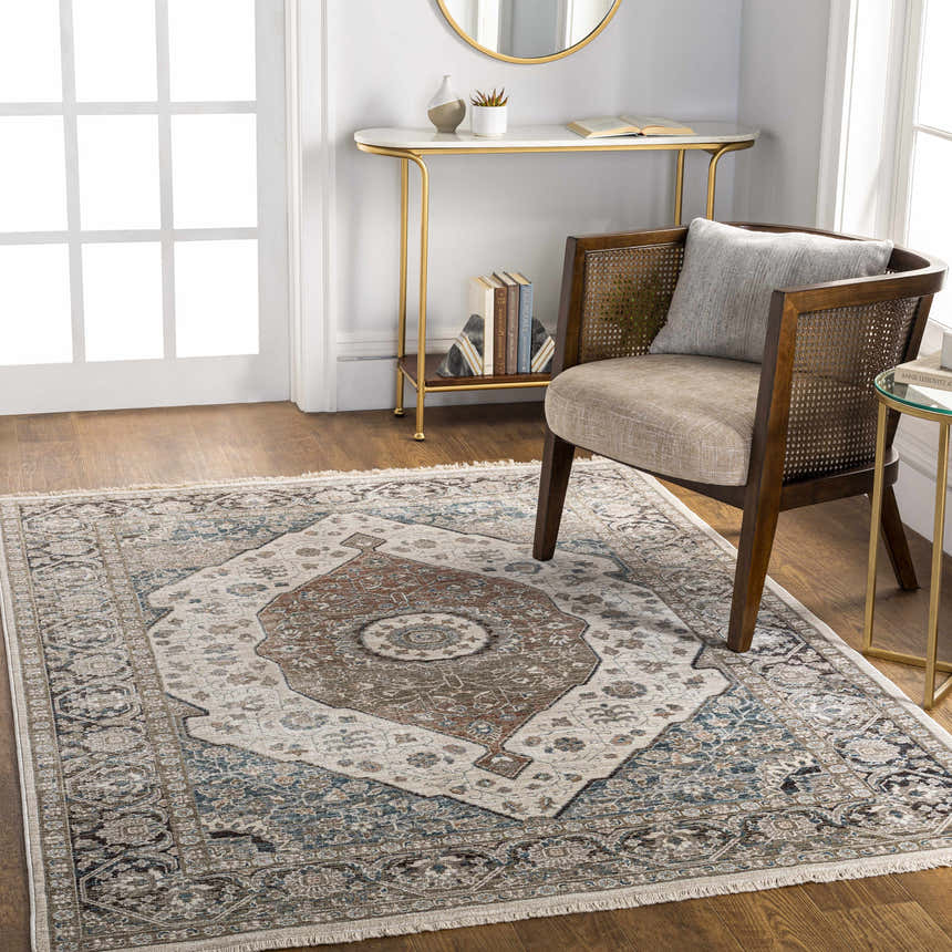 Light-filled entryway with a Baychester Area Rug in cream, brown, and blue under a wood chair and gold accent tables. Roomscene-Rectangle