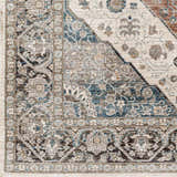 Close-up of the Baychester Area Rug, showcasing its traditional floral pattern in cream, denim, and brown hues. Swatch
