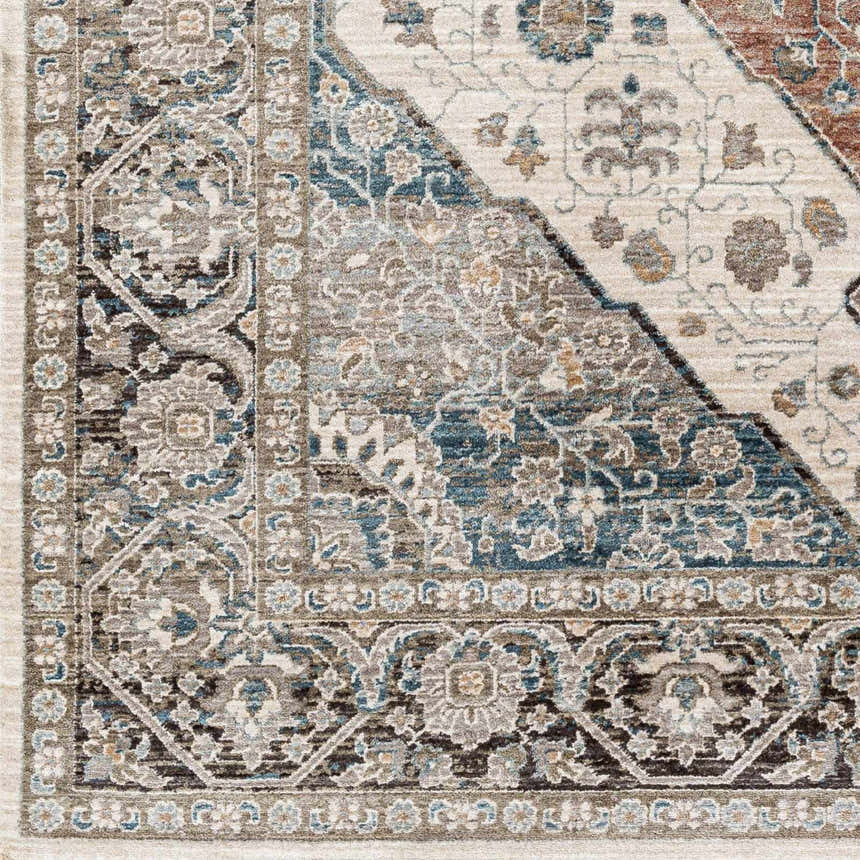 Close-up of the Baychester Area Rug, showcasing its traditional floral pattern in cream, denim, and brown hues. Swatch