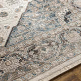 Close-up of the Baychester Area Rug showing its cream, denim, and brown traditional Oriental design and soft polyester texture. Texture