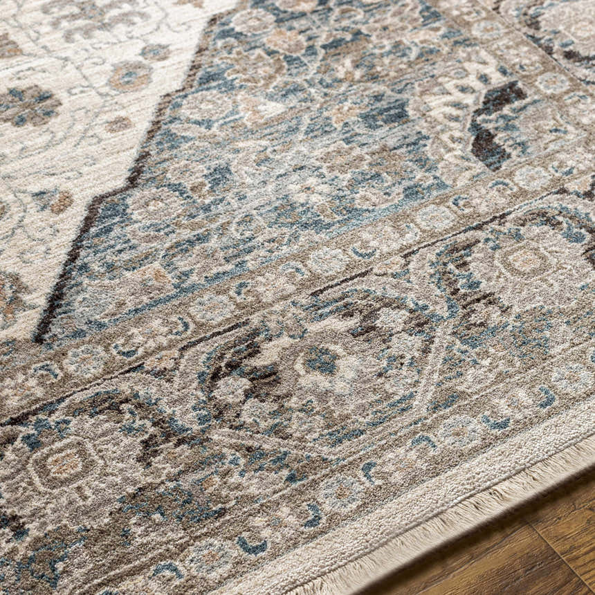 Close-up of the Baychester Area Rug showing its cream, denim, and brown traditional Oriental design and soft polyester texture. Texture