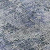 Close-up of Dalyn Luxury Bresca BC6 Blue Washable Area Rug. Features denim, light blue, and silver gray tones.