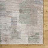 Close-up of the Anaisa Ivory Luxe Thick Area Rug showing its ivory, sage, and tan contemporary pattern and plush texture. Corner