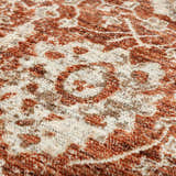 Close-up of the Dalyn Bergama BE6 Paprika area rug. Features a traditional floral pattern in paprika, brown, ivory, and light brown.
