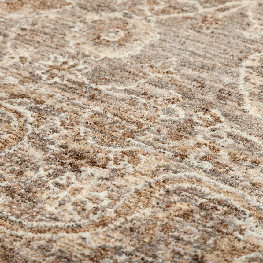 Close-up of the Dalyn Bergama BE6 Pebble Area Rug showing beige, chestnut, and ivory tones with a subtle traditional pattern.
