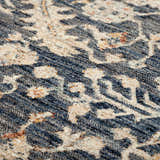 Close-up of the Dalyn Bergama BE8 Navy Area Rug, showing beige floral patterns on navy and spice. Soft, textured feel.