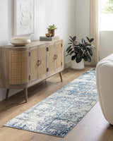 Living room scene with a Beverly Abstract Blue Area Rug runner, wood cabinet, and neutral decor. Roomscene-Runner