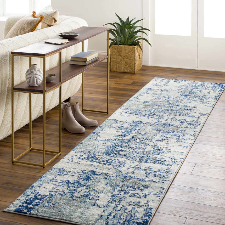Living room scene with a Beverly Abstract Blue Area Rug, sofa, console table, and wood floors. Roomscene-Runner