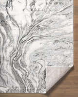 Close-up of the Brandi Gray Marble Area Rug, showcasing its beige, cream, and gray contemporary marble design. Fold