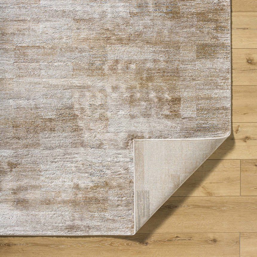 Close-up of the Bridie Luxe Thick Area Rug showing its ivory and tan contemporary pattern and texture on wood floor. Fold