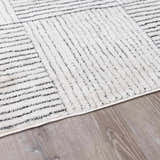 Close up of the Modern Scandi Architect I Area Rug, ivory high pile with black geometric line pattern. Pile