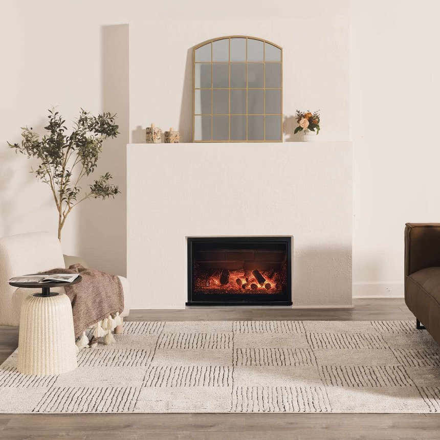 Living room scene with Modern Scandi Architect I Area Rug, fireplace, chair, and brown sofa. Ivory and black color palette. Roomscene-Rectangle