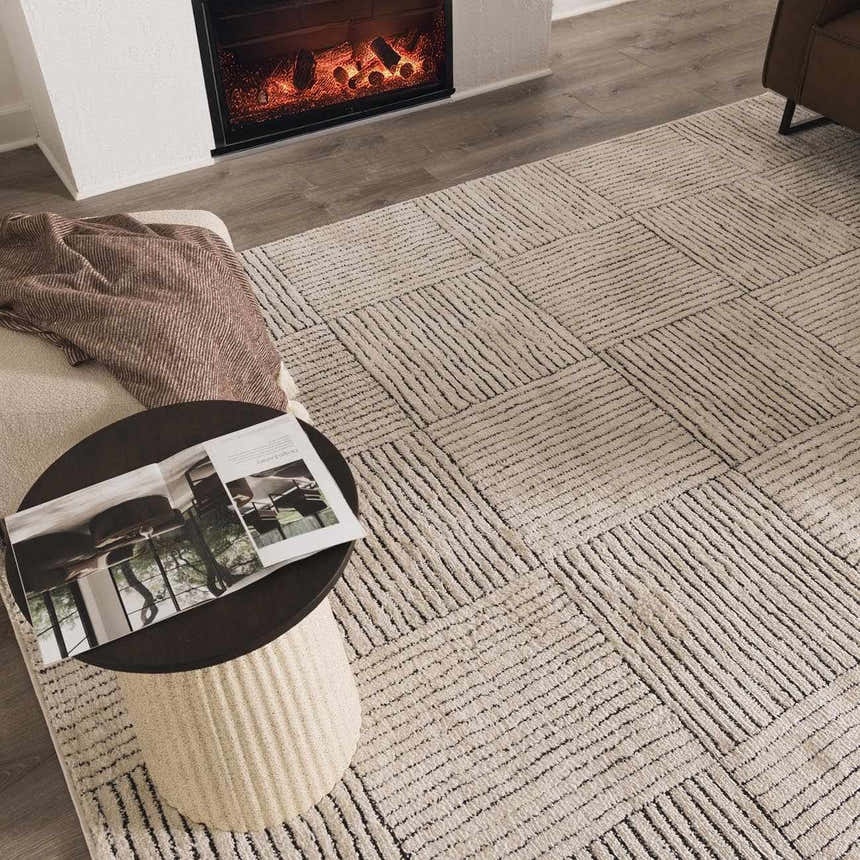 Cozy living room scene with a Modern Scandi Architect I Area Rug in ivory and black, side table, and fireplace. Roomscene-Rectangle