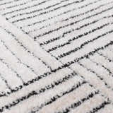 Close-up of the Modern Scandi Architect I Area Rug. High pile ivory rug with a geometric black line pattern. Texture