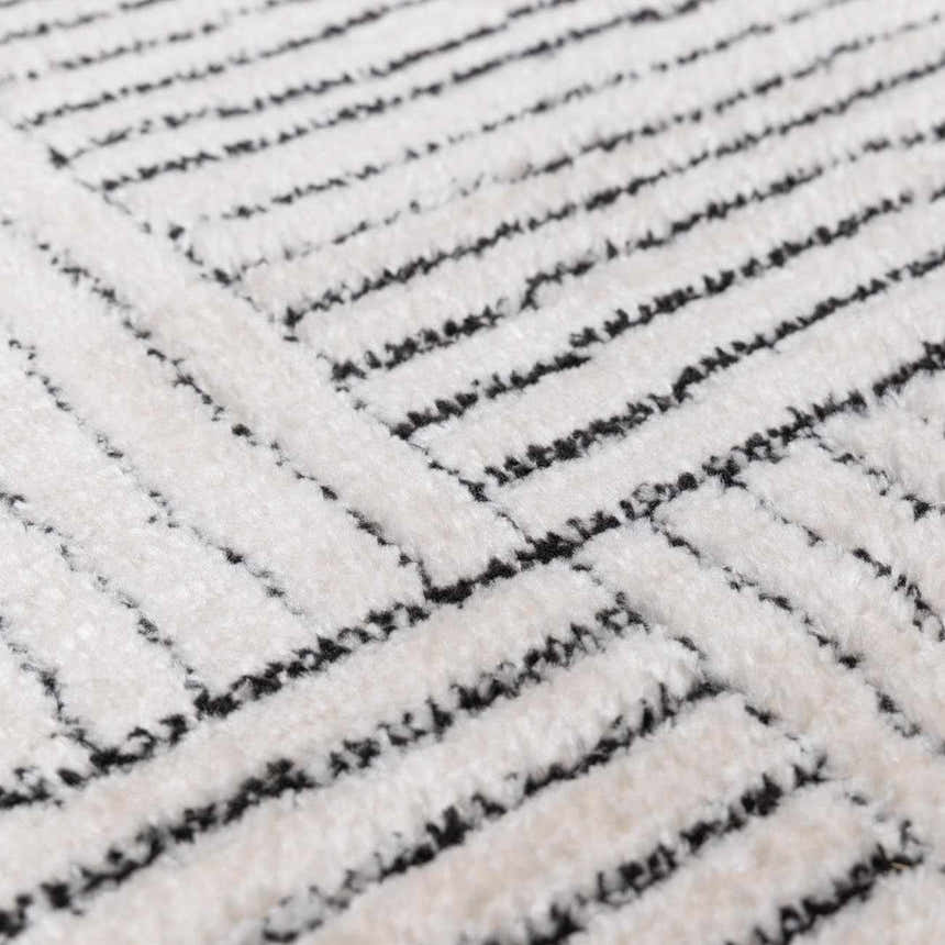 Close-up of the Modern Scandi Architect I Area Rug. High pile ivory rug with a geometric black line pattern. Texture