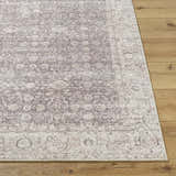 Close-up of the beige and cream Spokane Machine Woven PNWSP-2302 area rug with a traditional design on wood floors. Front