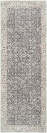 Close-up of the Spokane Machine Woven rug. Features a traditional floral pattern in charcoal, ivory, and tan. Design-Runner