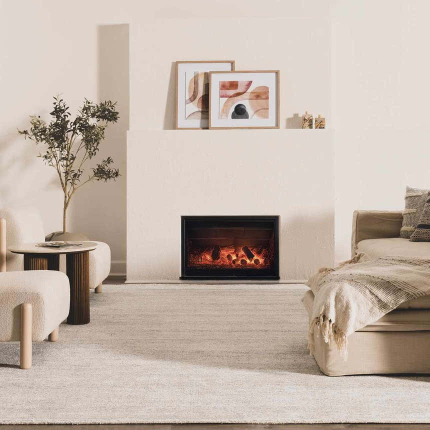 Living room scene with fireplace and neutral decor, featuring the Orcas Hand Tufted Wool-Blend Rug in Slate. Roomscene-Rectangle