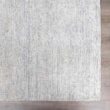 Close-up of the Orcas Hand Tufted Wool-Blend Rug in Slate, showing its striped texture and blue and cream colors. Swatch