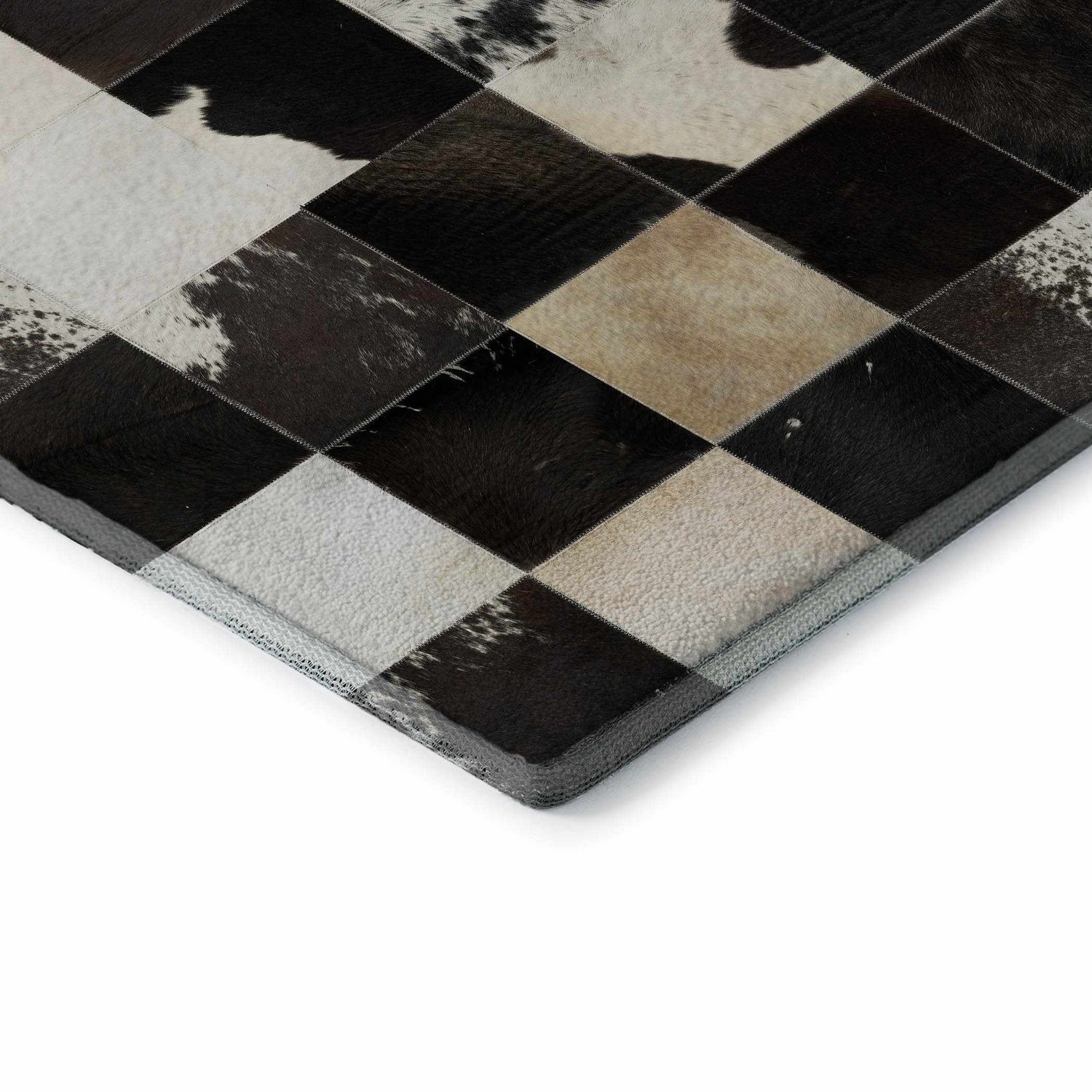 Close up of the Dalyn Luxury Bozeman BM10 Black Washable Area Rug, showing black, beige, and chestnut diamond patchwork design.